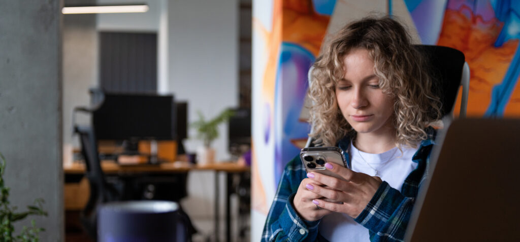 NERDZ LAB team member reviewing an app on a smartphone NERDZ LAB team member reviewing an app on a smartphone in the office